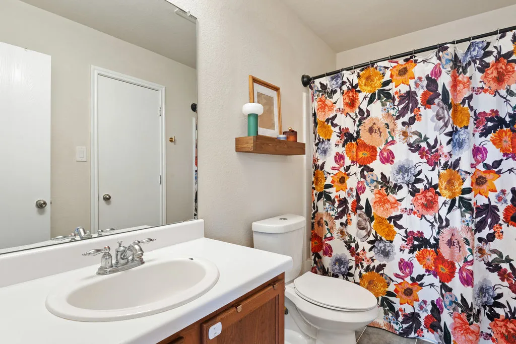 a bathroom with a sink and a mirror with toilet