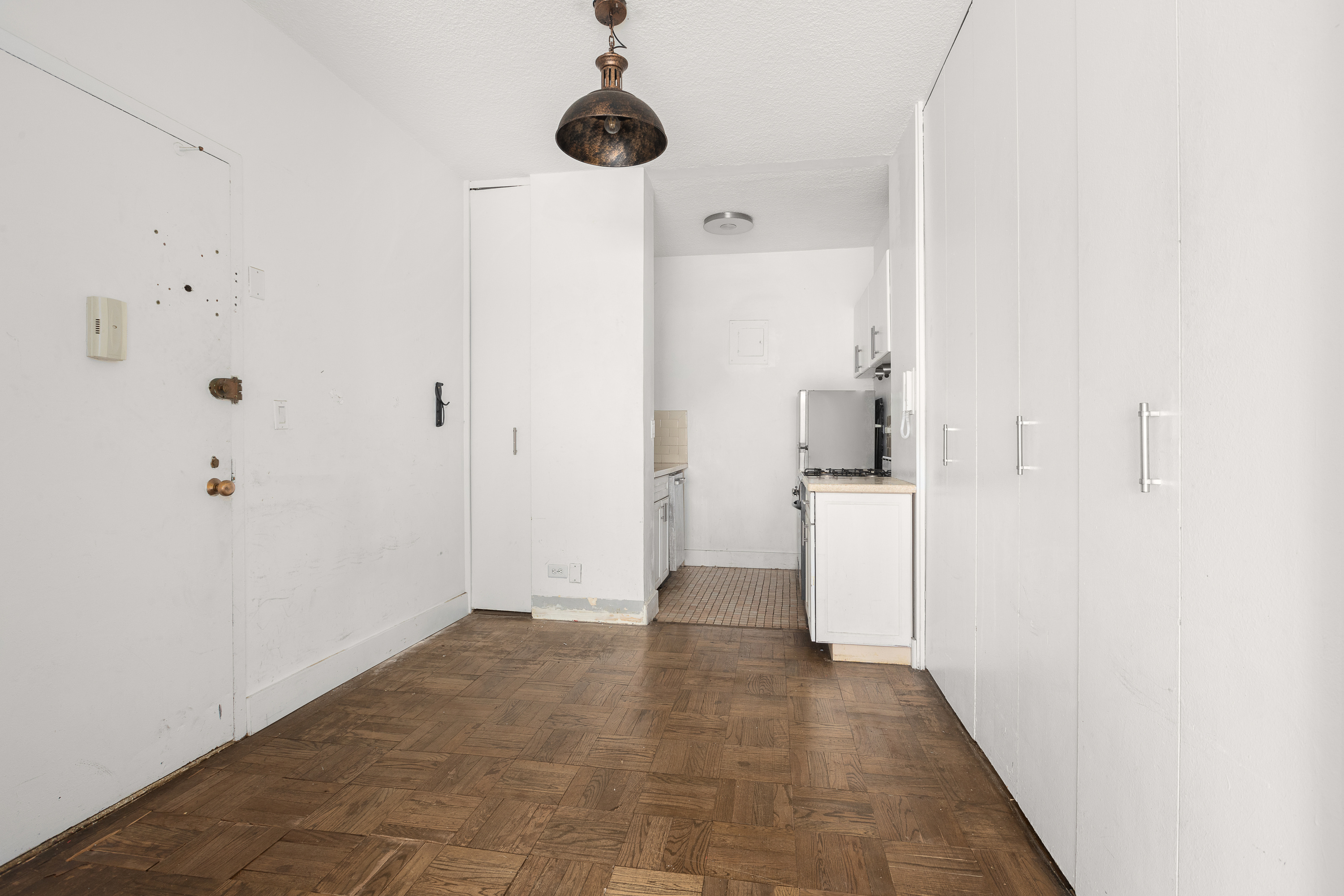 60 East 8th Street, Unit 18J Manhattan, NY 10003 - Photo 6 of 10 a view of a hallway with a white walls