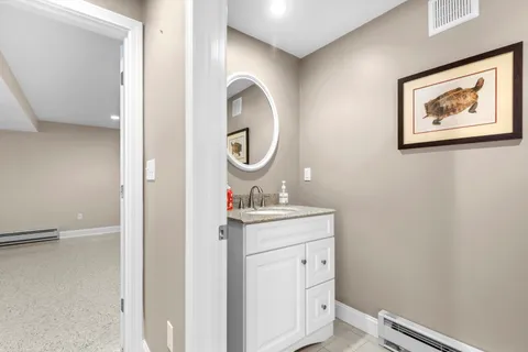 a bathroom with a sink a vanity and a mirror