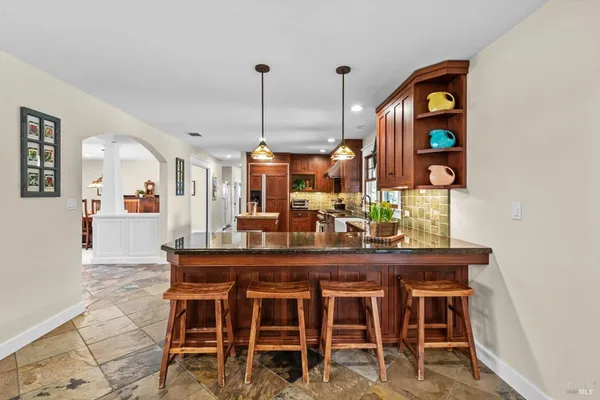 a view of a house with backyard and sitting area