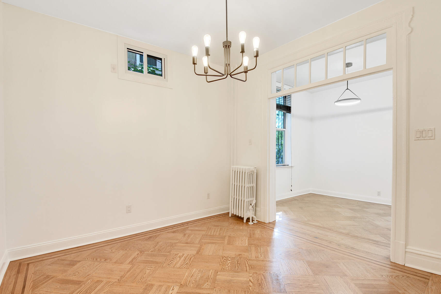 514 Hart Street, Unit PARLOR Brooklyn, NY 11221 - Photo 2 of 9 a view of empty room with wooden floor and ceiling fan