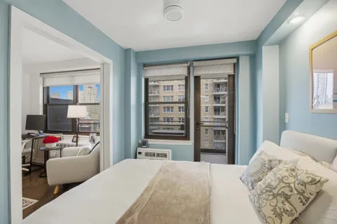 a bedroom with furniture and a flat screen tv