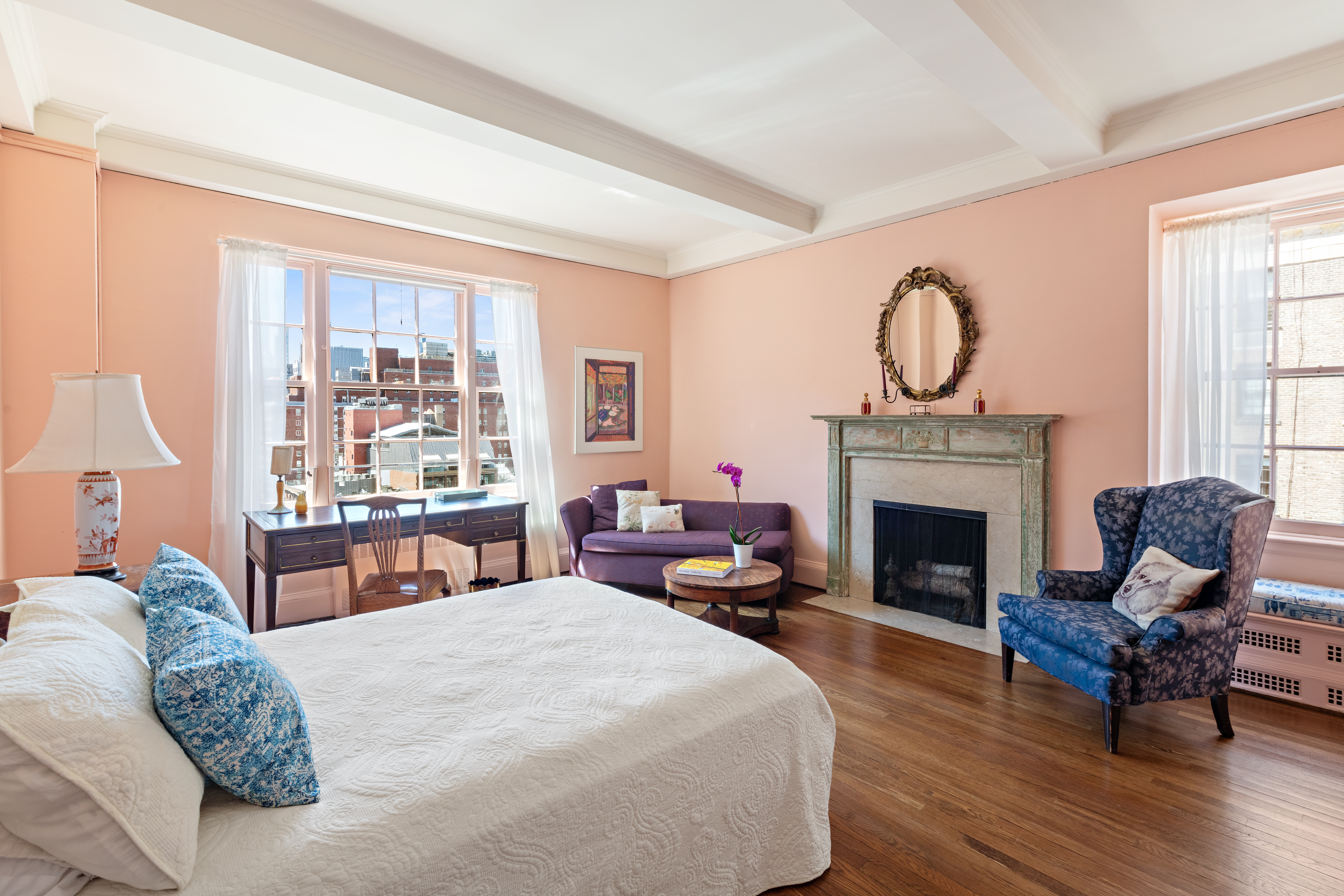 151 East 79th Street Manhattan, NY 10075 - Photo 8 of 15 a living room with furniture a fireplace and large windows