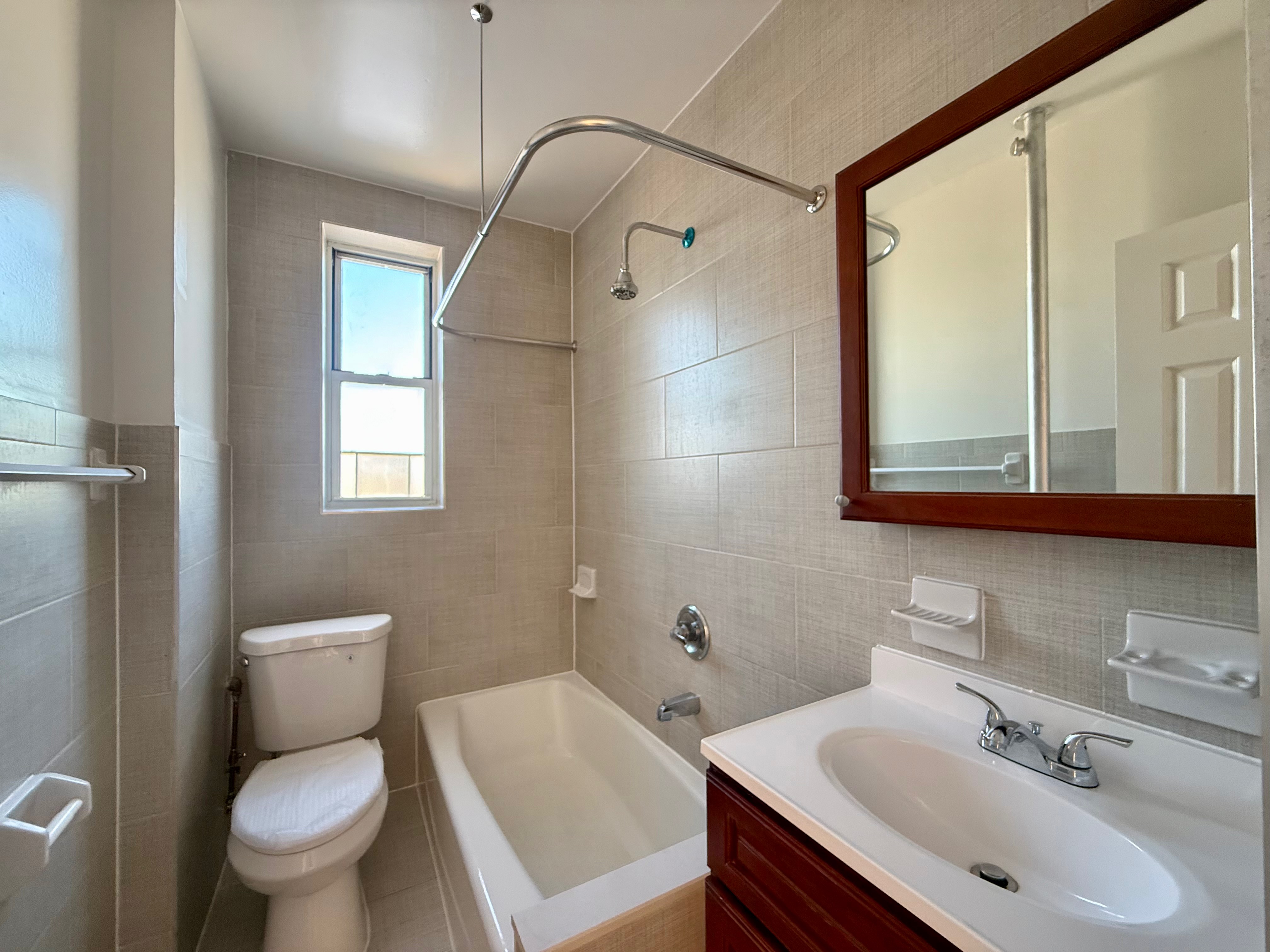 6309 Bay Parkway, Unit F5 Brooklyn, NY 11204 - Photo 6 of 7 a bathroom with a sink toilet and shower