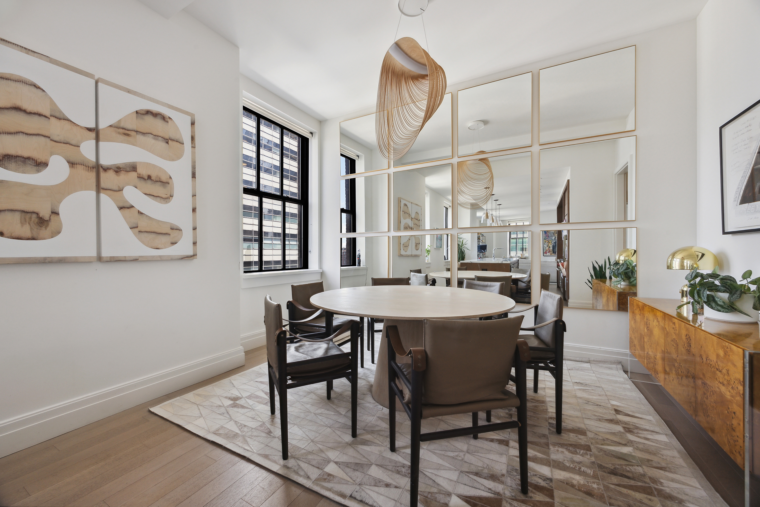 100 Barclay Street, Unit 15B Manhattan, NY 10007 - Photo 7 of 16 a dining room with furniture and wooden floor