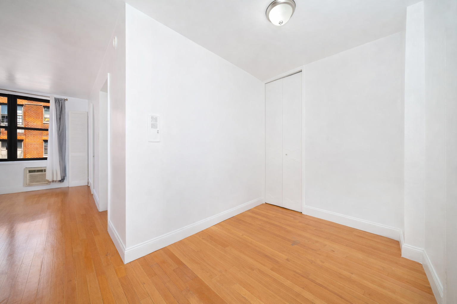 1270 East 51st Street, Unit 6M Brooklyn, NY 11234 - Photo 4 of 12 a view of empty room with wooden floor and fan