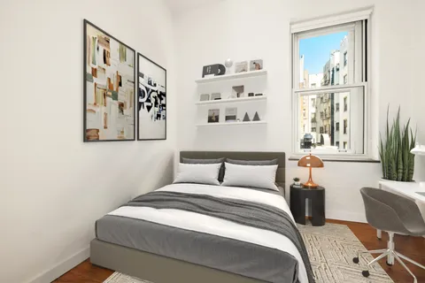 a view of a small space with wooden floor and a window