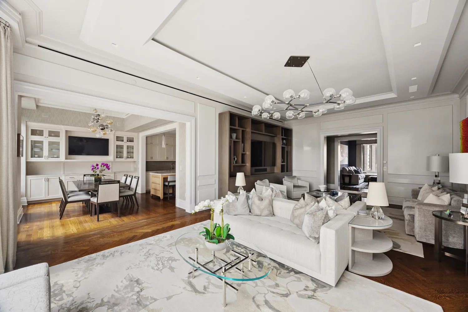 a living room with furniture and a chandelier