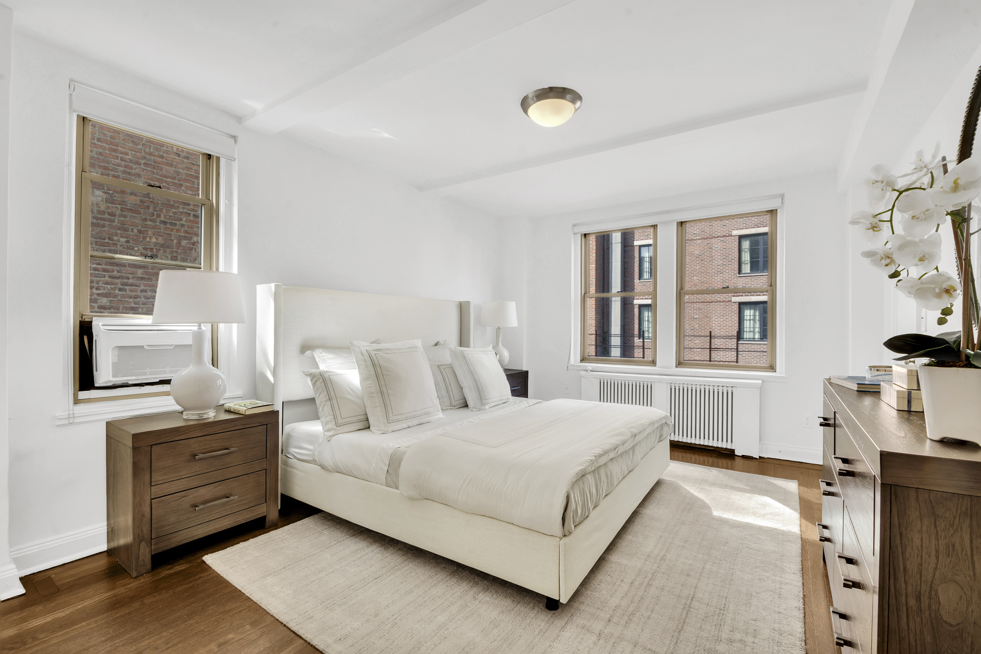 59 West 12th Street, Unit 6A Manhattan, NY 10011 - Photo 7 of 11 a bedroom with a bed and a flat tv screen on dresser