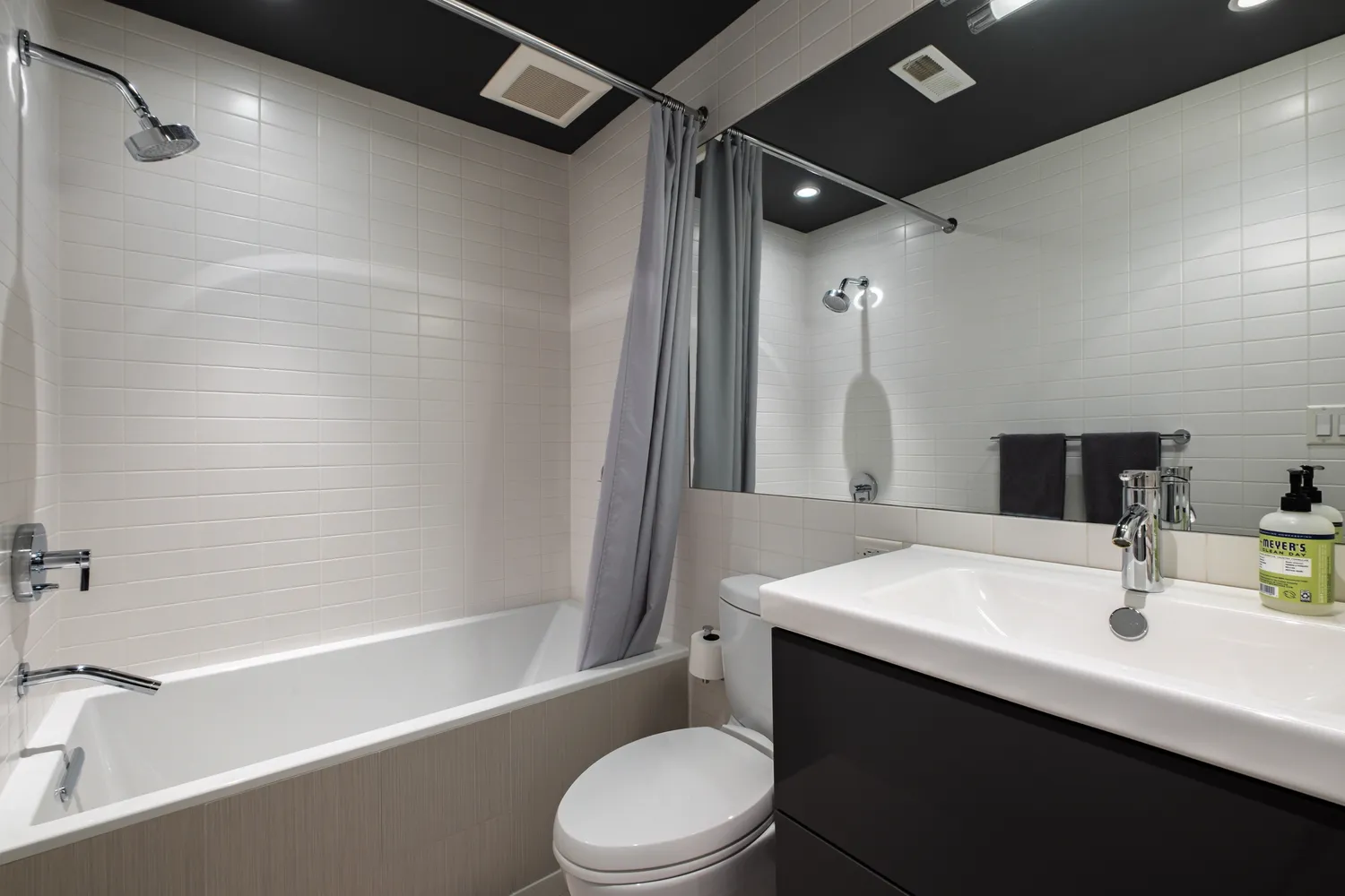 a kitchen with white cabinets and appliances