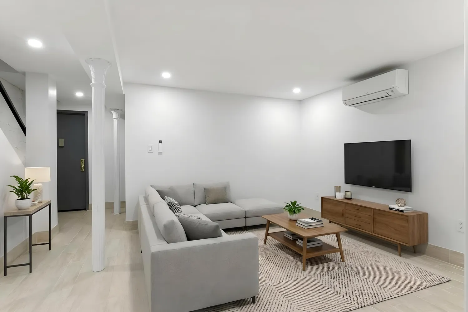 a living room with furniture and a flat screen tv