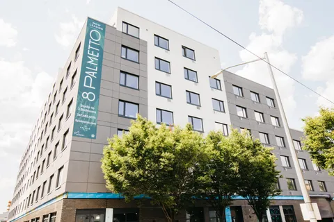 a picture of a book and a white bed