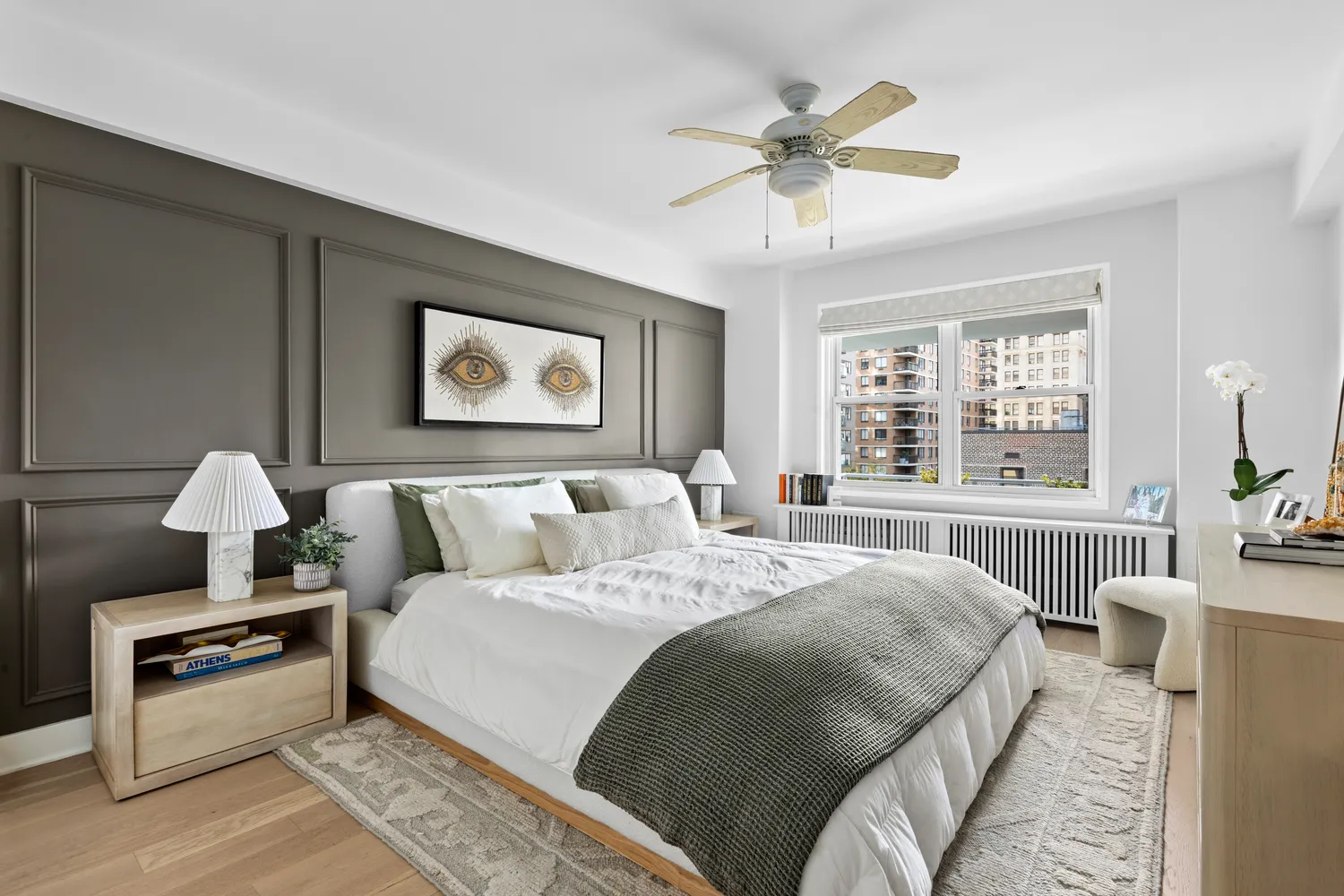 a bedroom with bed and a large window