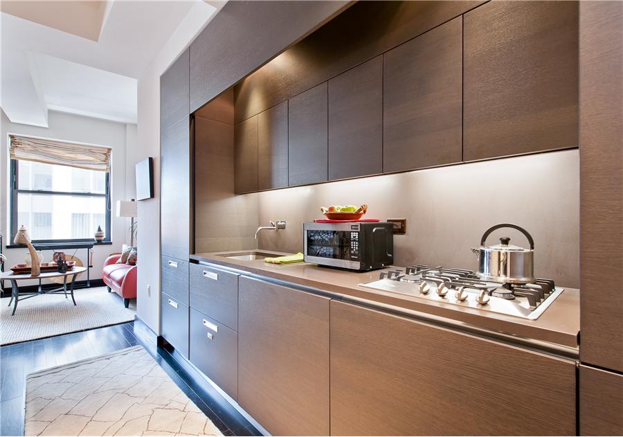 20 Pine Street, Unit 2211 Manhattan, NY 10005 - Photo 4 of 6 a kitchen with stainless steel appliances a sink a stove and cabinets