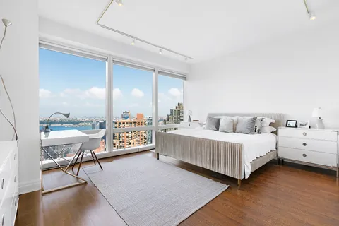 a living room with furniture and a large mirror
