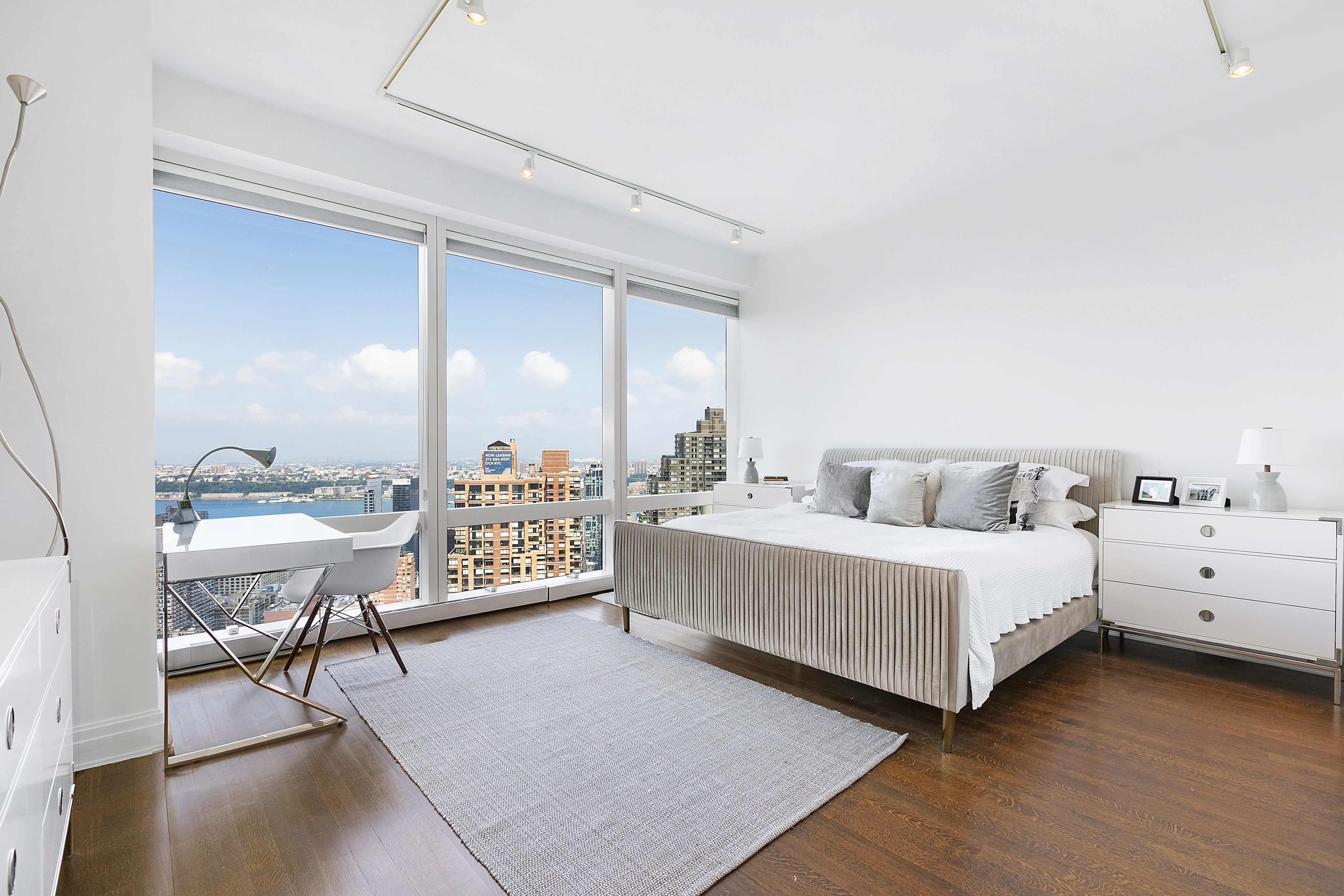 25 Columbus Circle, Unit 65E Manhattan, NY 10019 - Photo 6 of 11 a living room with furniture and a large mirror