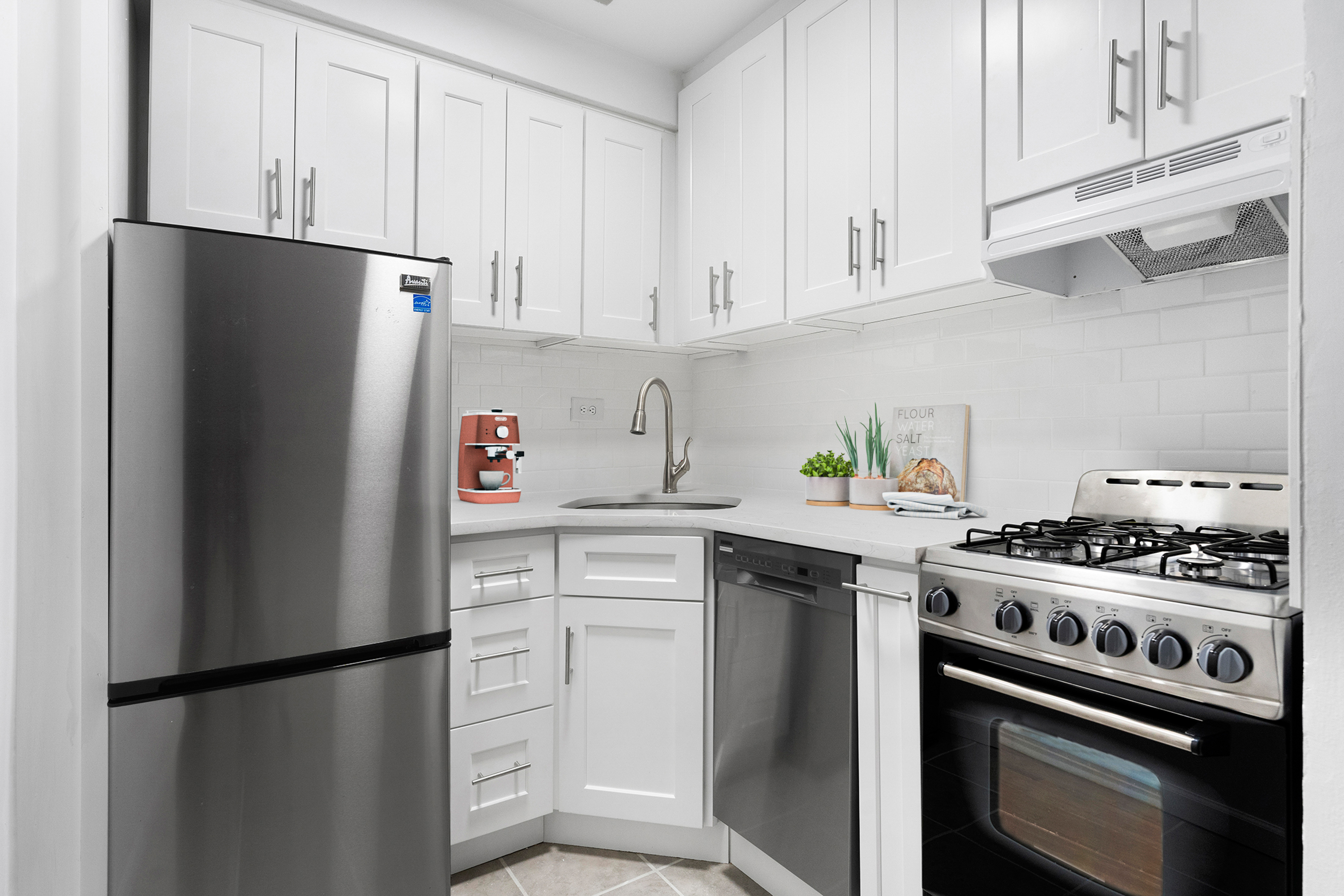 165 Christopher Street, Unit LV Manhattan, NY 10014 - Photo 5 of 16 a kitchen with stainless steel appliances white cabinets and a refrigerator