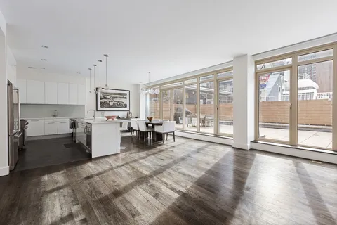 a living room with furniture and large windows