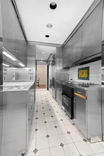 a kitchen with stainless steel appliances kitchen island granite countertop a sink and cabinets