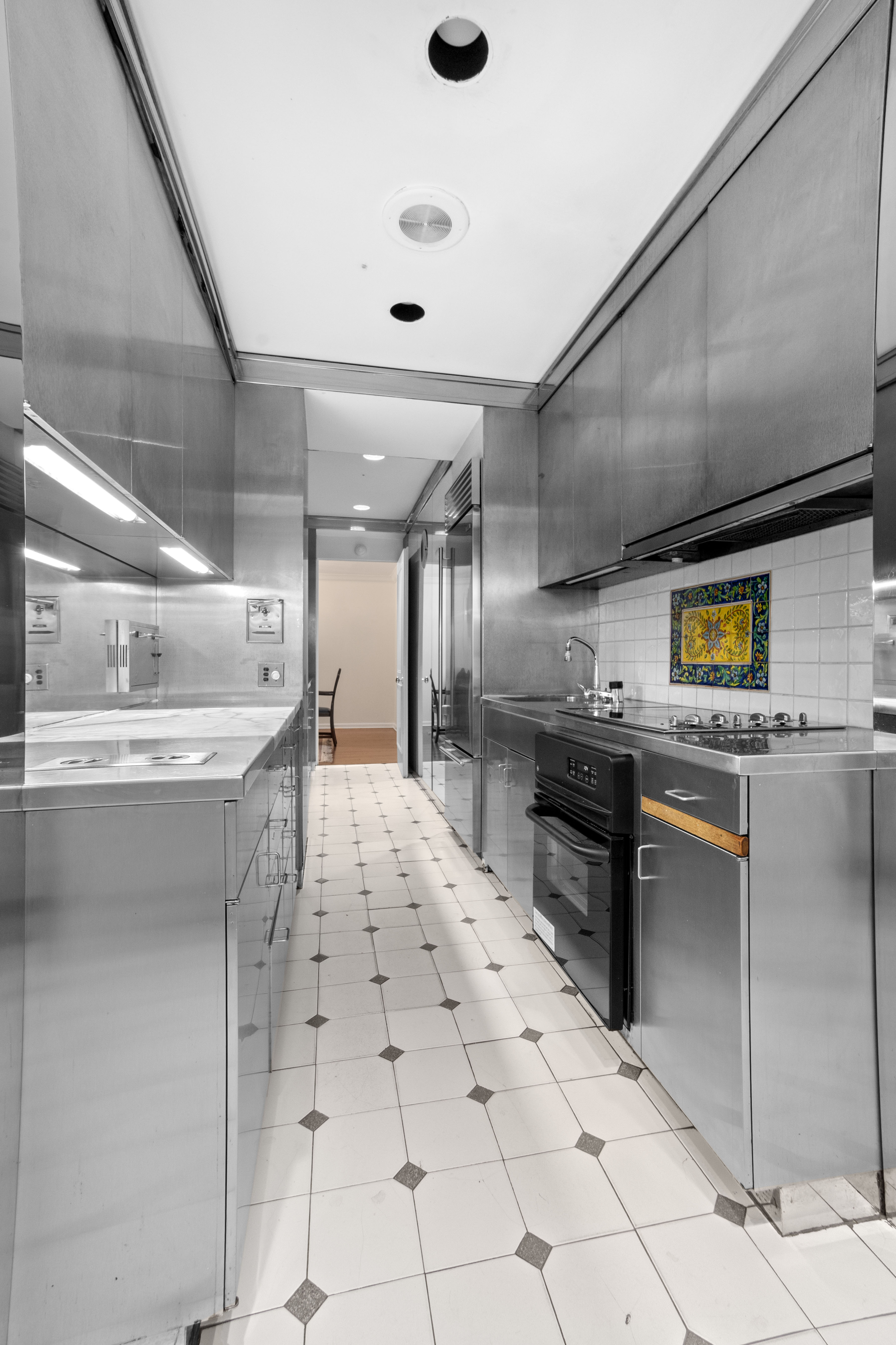 16 Sutton Place, Unit 1A/1B Manhattan, NY 10022 - Photo 5 of 25 a kitchen with stainless steel appliances kitchen island granite countertop a sink and cabinets