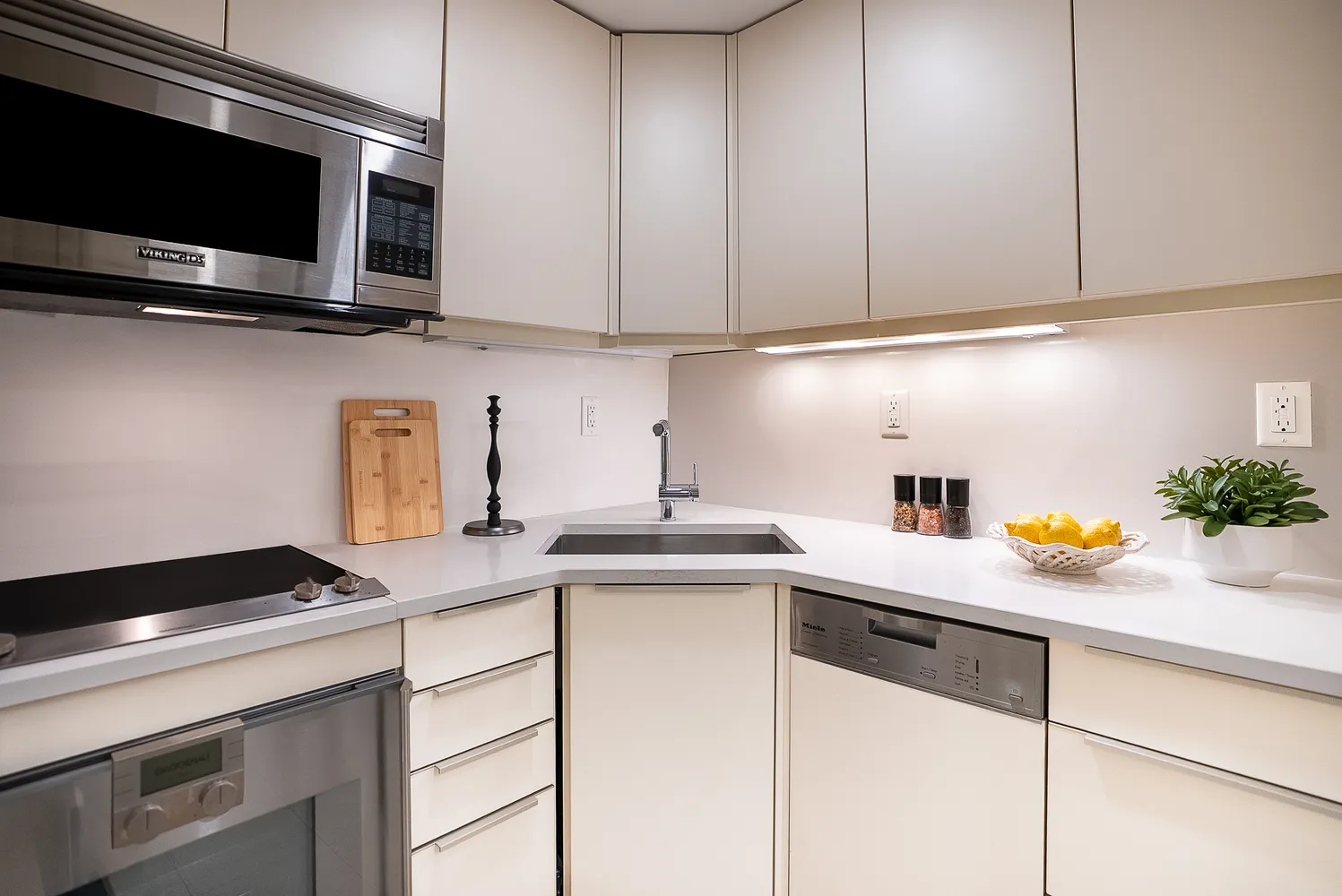 a kitchen with stainless steel appliances a sink a stove and cabinets