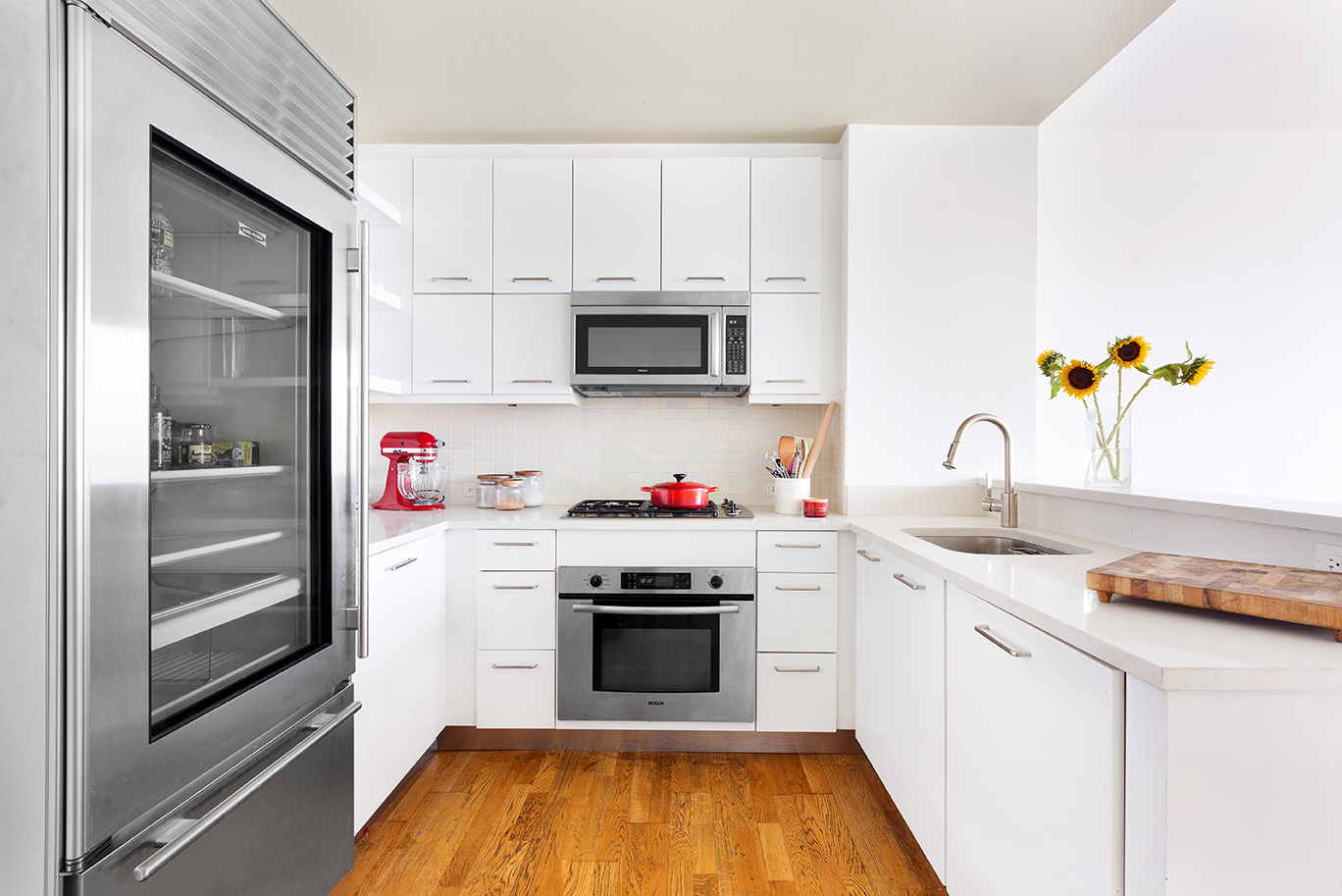 635 West 42nd Street, Unit 17D Manhattan, NY 10036 - Photo 2 of 6 a kitchen with a sink cabinets and stainless steel appliances