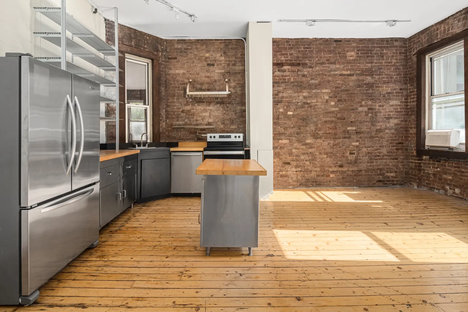 a kitchen with stainless steel appliances granite countertop a refrigerator a sink and a stove