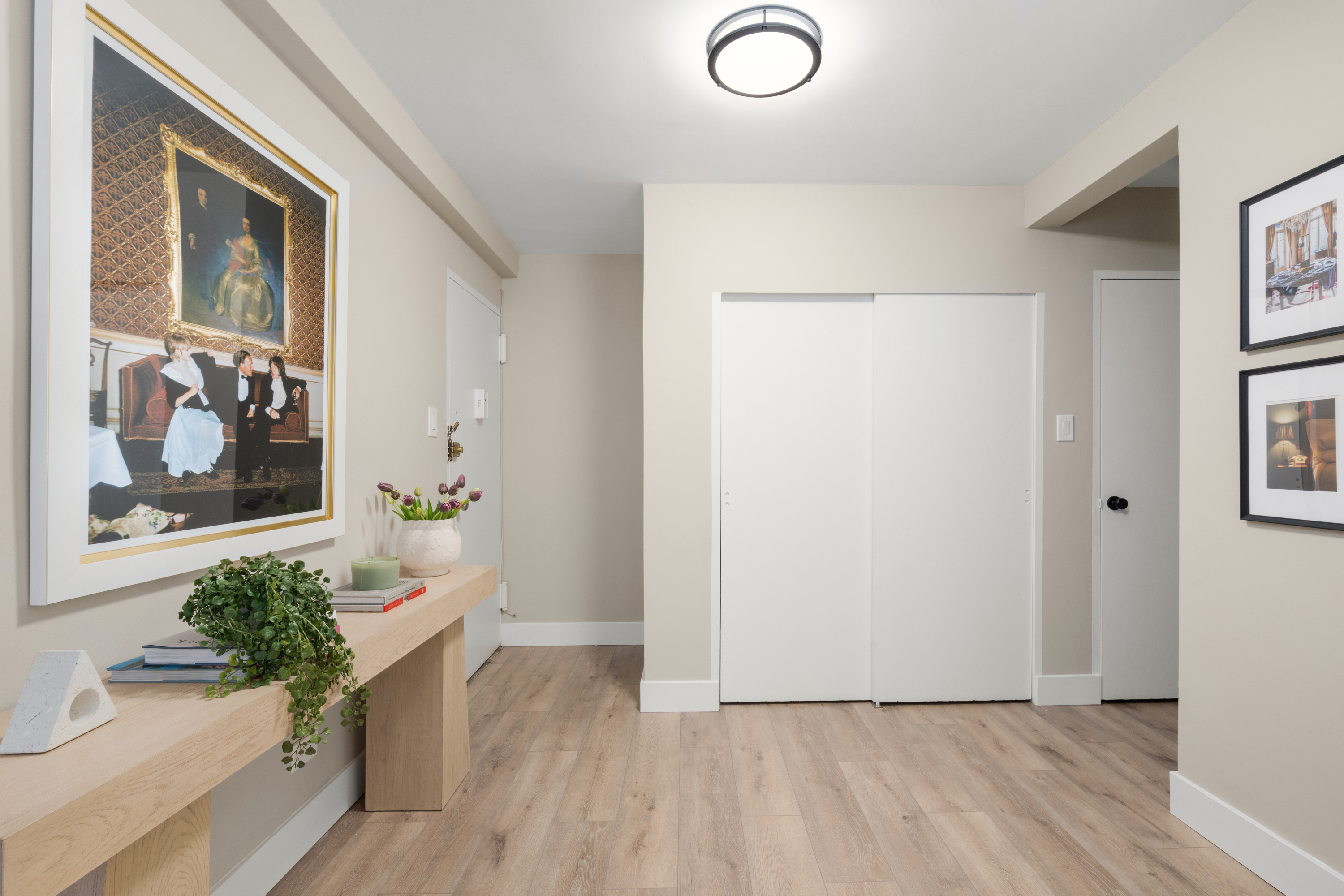 347 East 53rd Street, Unit 2C Manhattan, NY 10022 - Photo 7 of 18 a view of a hallway with wooden floor and a potted plant