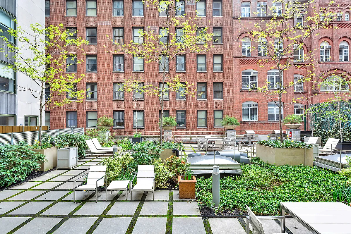 99 John Street, Unit 819 Manhattan, NY 10038 - Photo 15 of 20 a view of a building with garden and sitting area