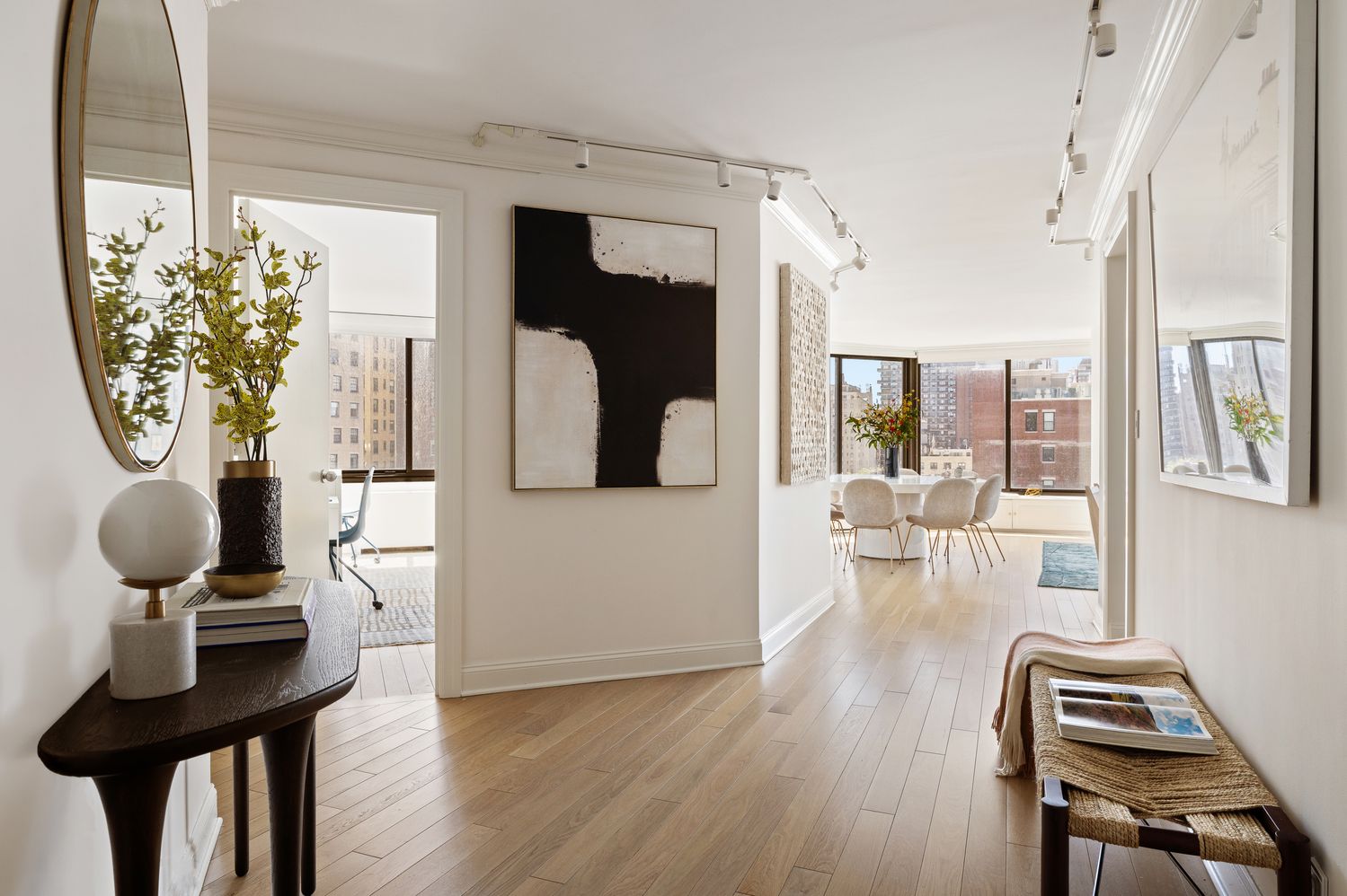 a living room with furniture a dining table and chairs with wooden floor