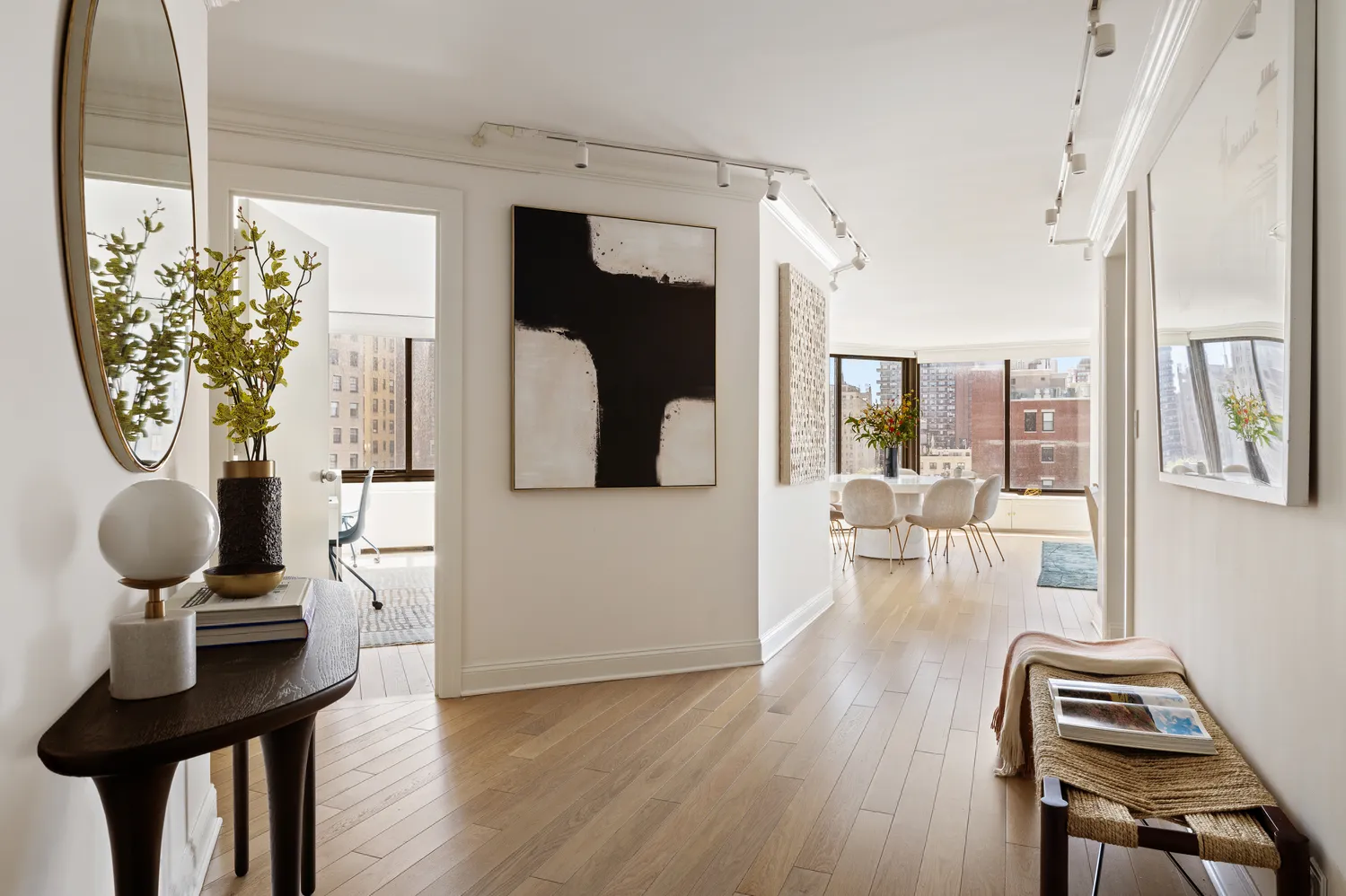 a living room with furniture a dining table and chairs with wooden floor