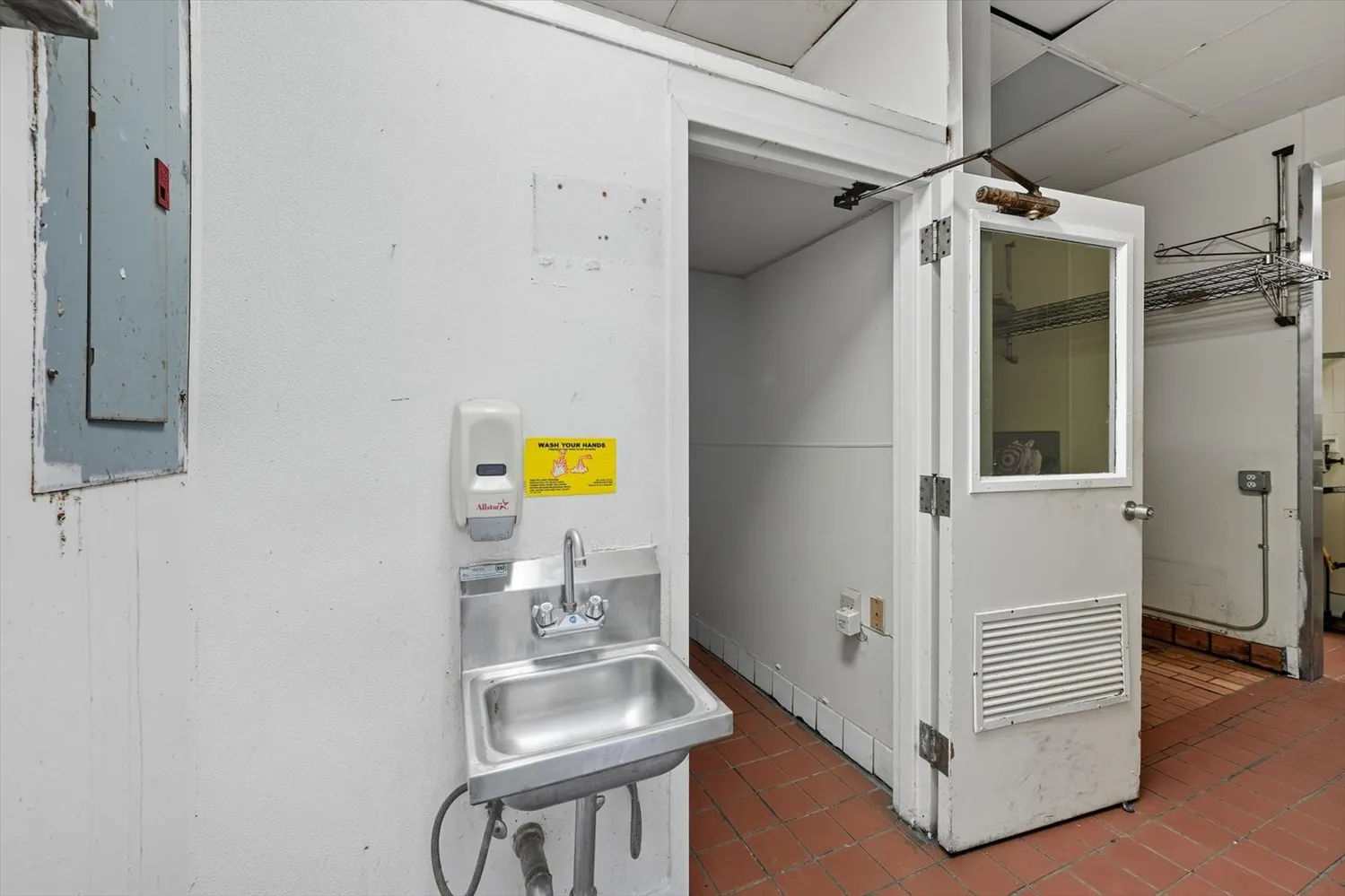 a bathroom with a sink toilet and a mirror