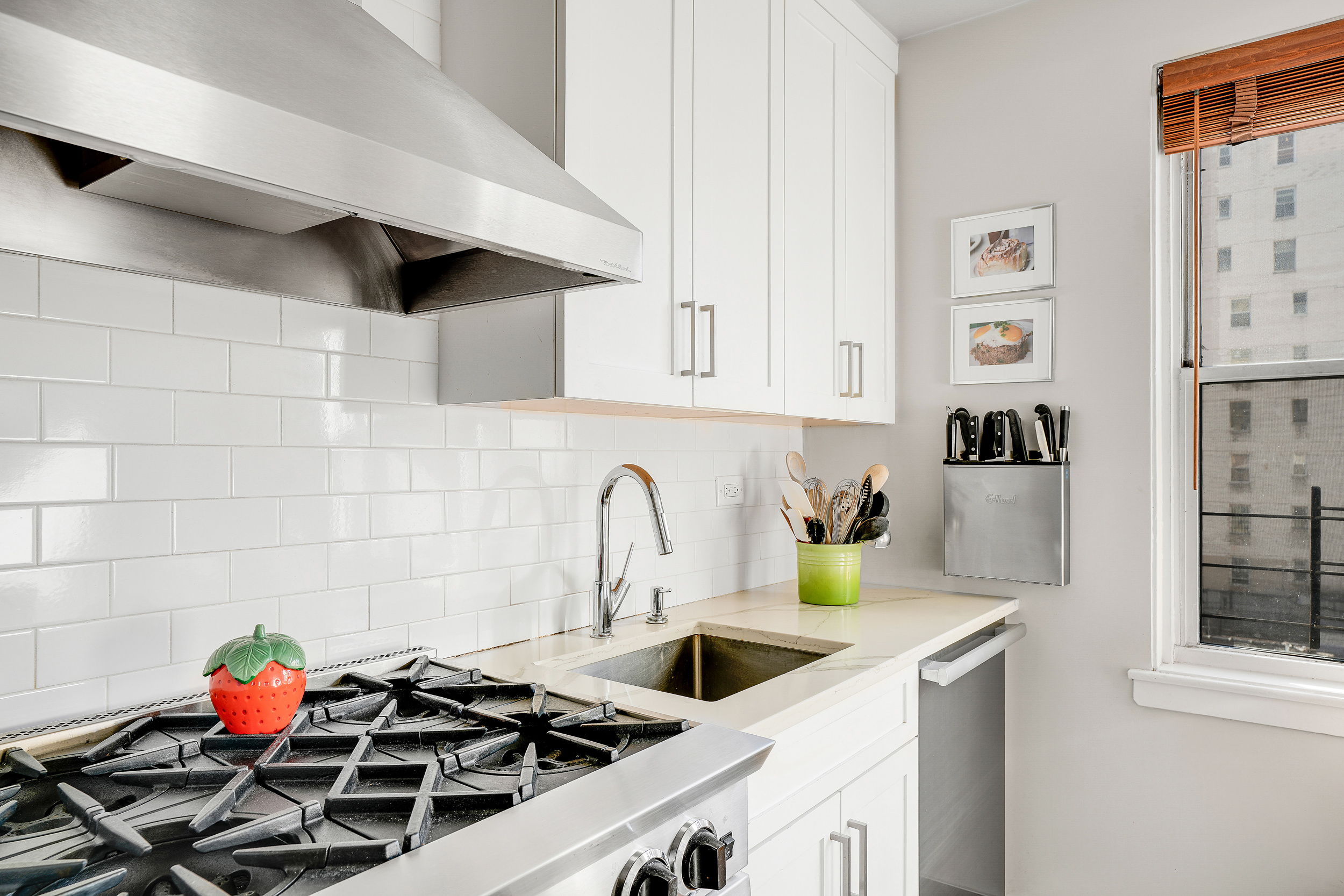 201 East 37th Street, Unit 11D Manhattan, NY 10016 - Photo 7 of 11 a kitchen with a sink and a stove top oven