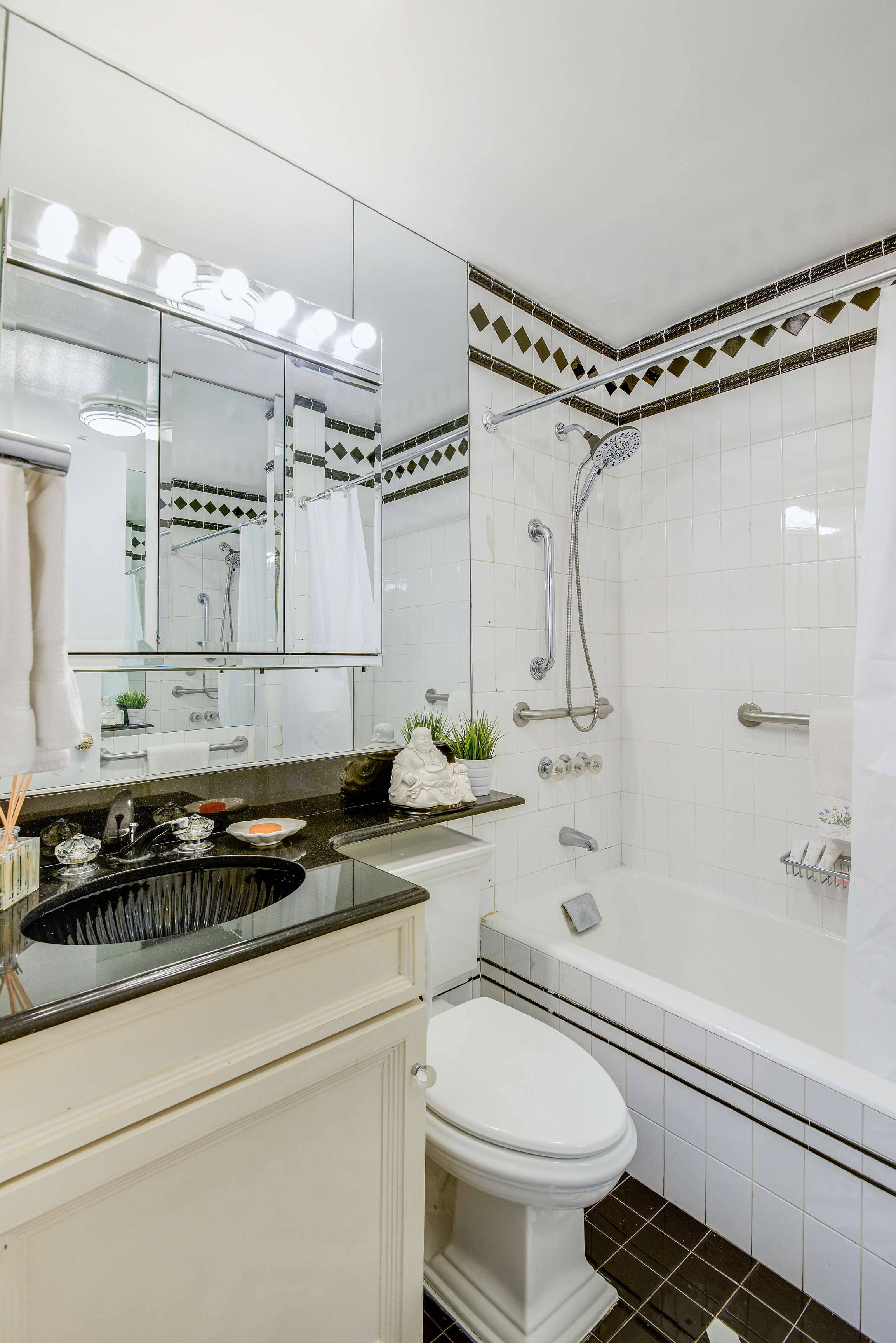 200 Central Park South, Unit 14B Manhattan, NY 10019 - Photo 15 of 17 a bathroom with a sink a toilet and shower