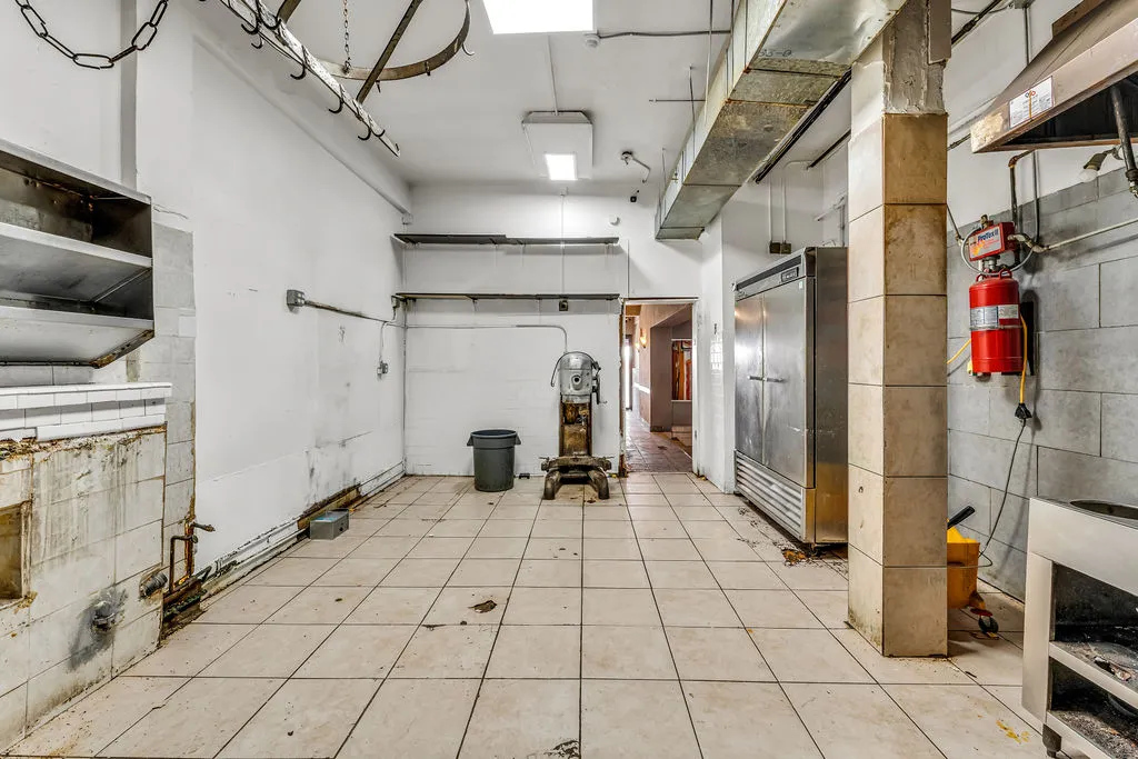 a view of a hallway with dining area and chandelier