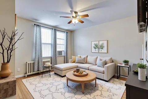 a living room with furniture a rug and a chandelier