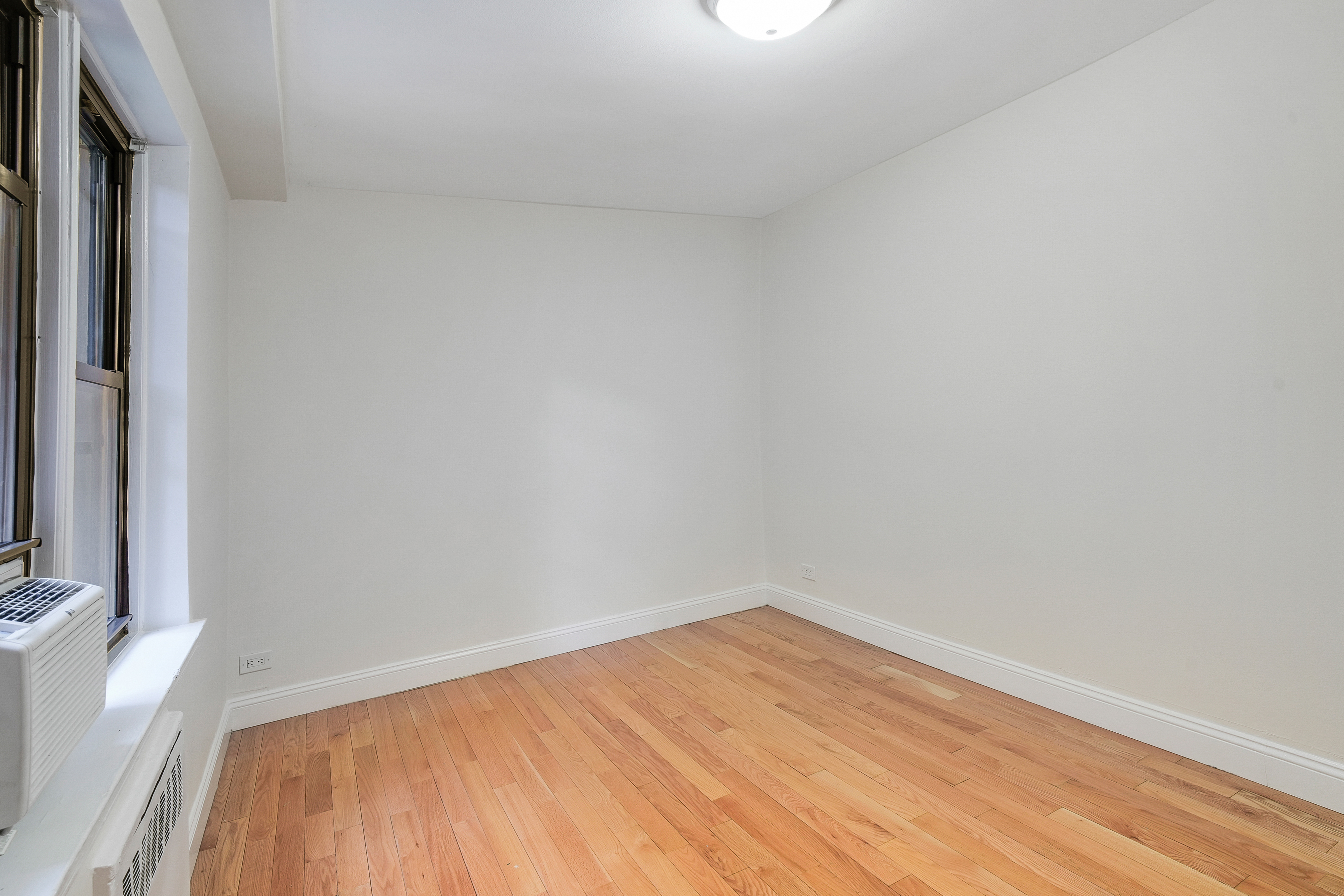 3840 Greystone Avenue, Unit 1K Bronx, NY 10463 - Photo 12 of 13 a view of empty room with wooden floor