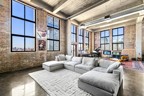 a living room with furniture and a floor to ceiling window