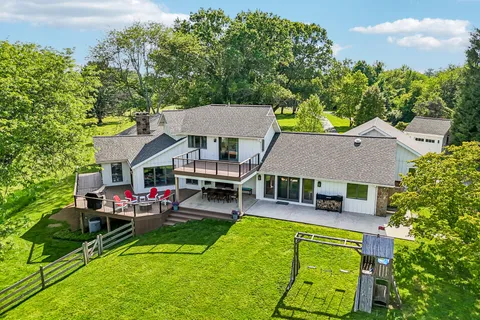 an aerial view of a house with swimming pool and porch