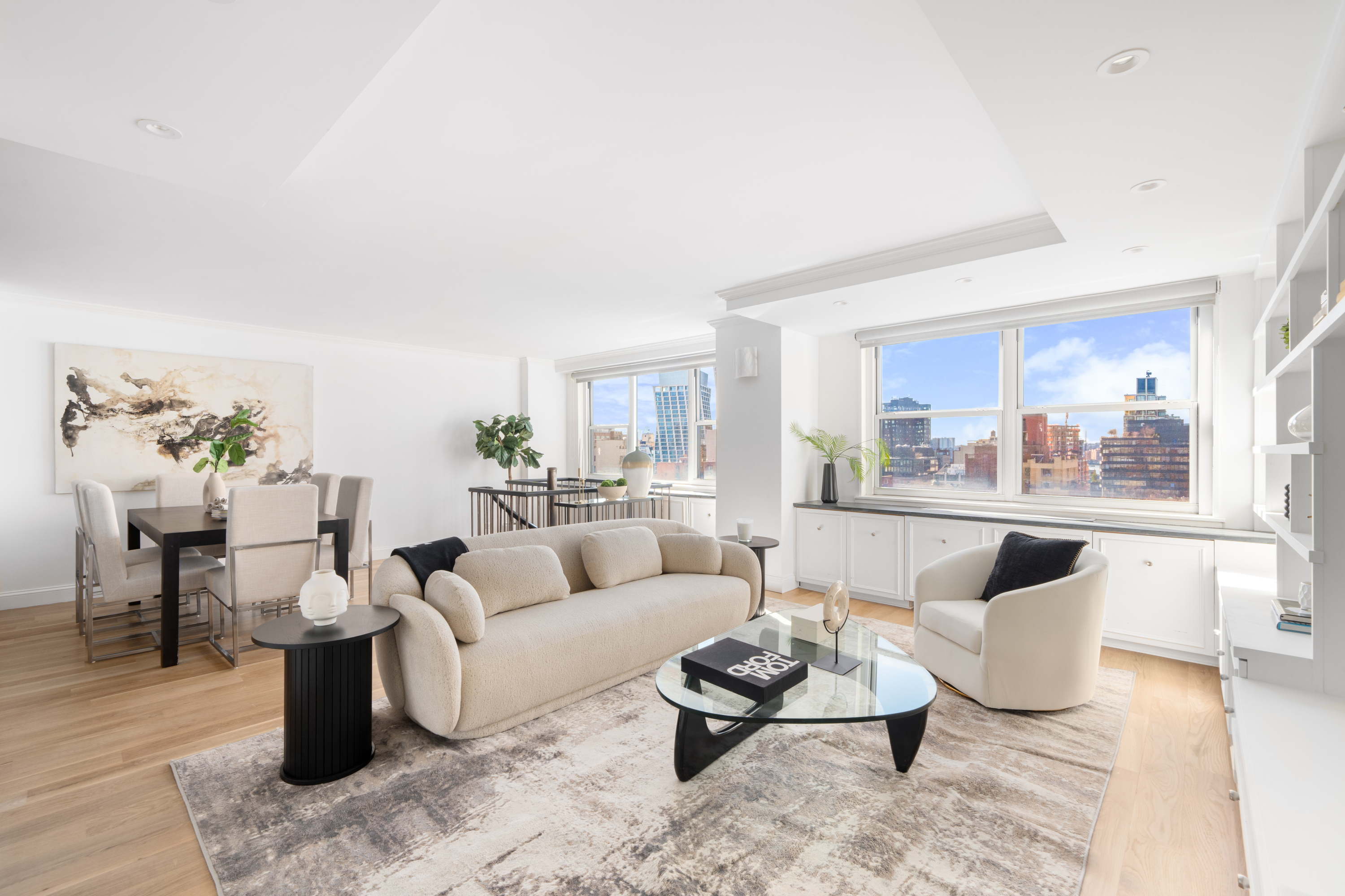 360 West 22nd Street, Unit 15C-14C Manhattan, NY 10011 - Photo 1 of 16 a living room with furniture and a large window