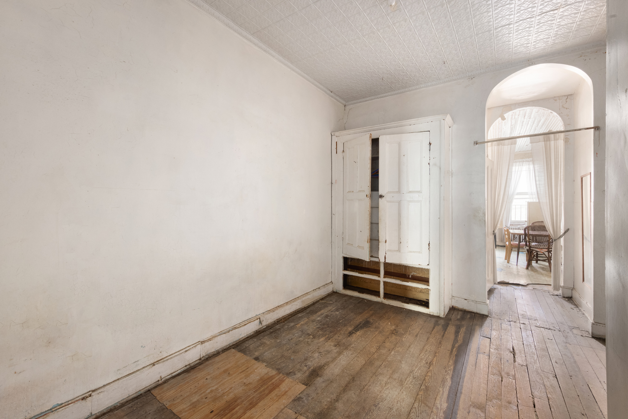 221 Nassau Avenue Brooklyn, NY 11222 - Photo 7 of 11 an empty room with wooden floor and white walls