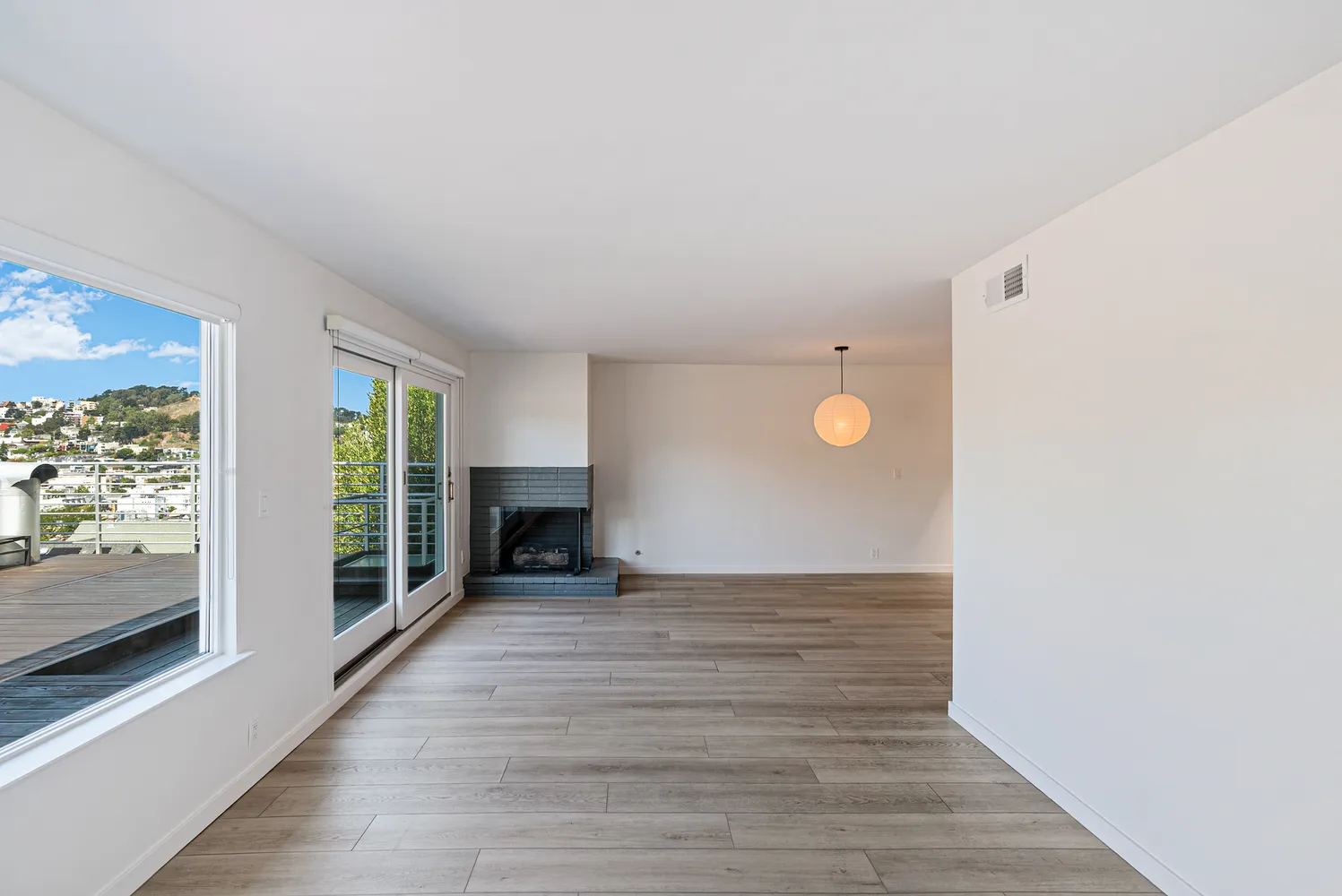 a view of a livingroom with wooden floor and furniture