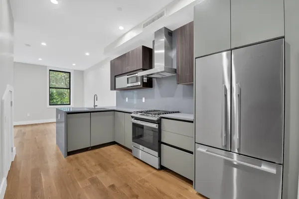 a kitchen with stainless steel appliances granite countertop a refrigerator and a sink