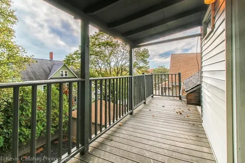 a view of a balcony with wooden floor