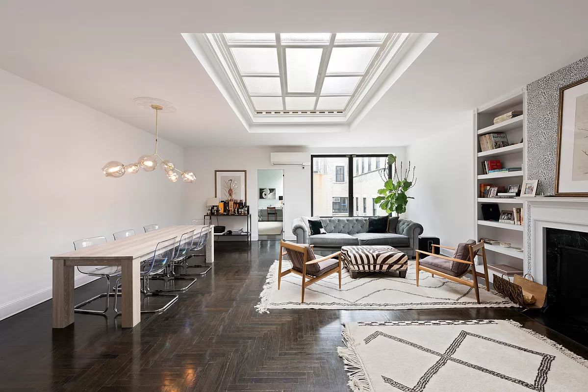 a living room with furniture a flat screen tv and a large window