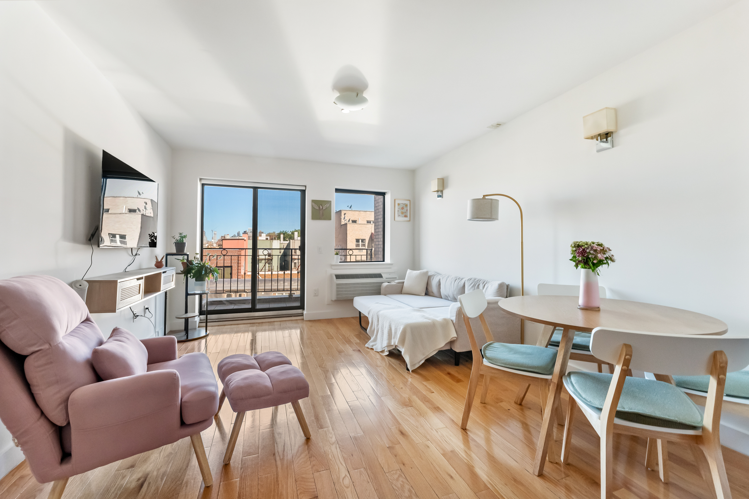 a living room with furniture and wooden floor