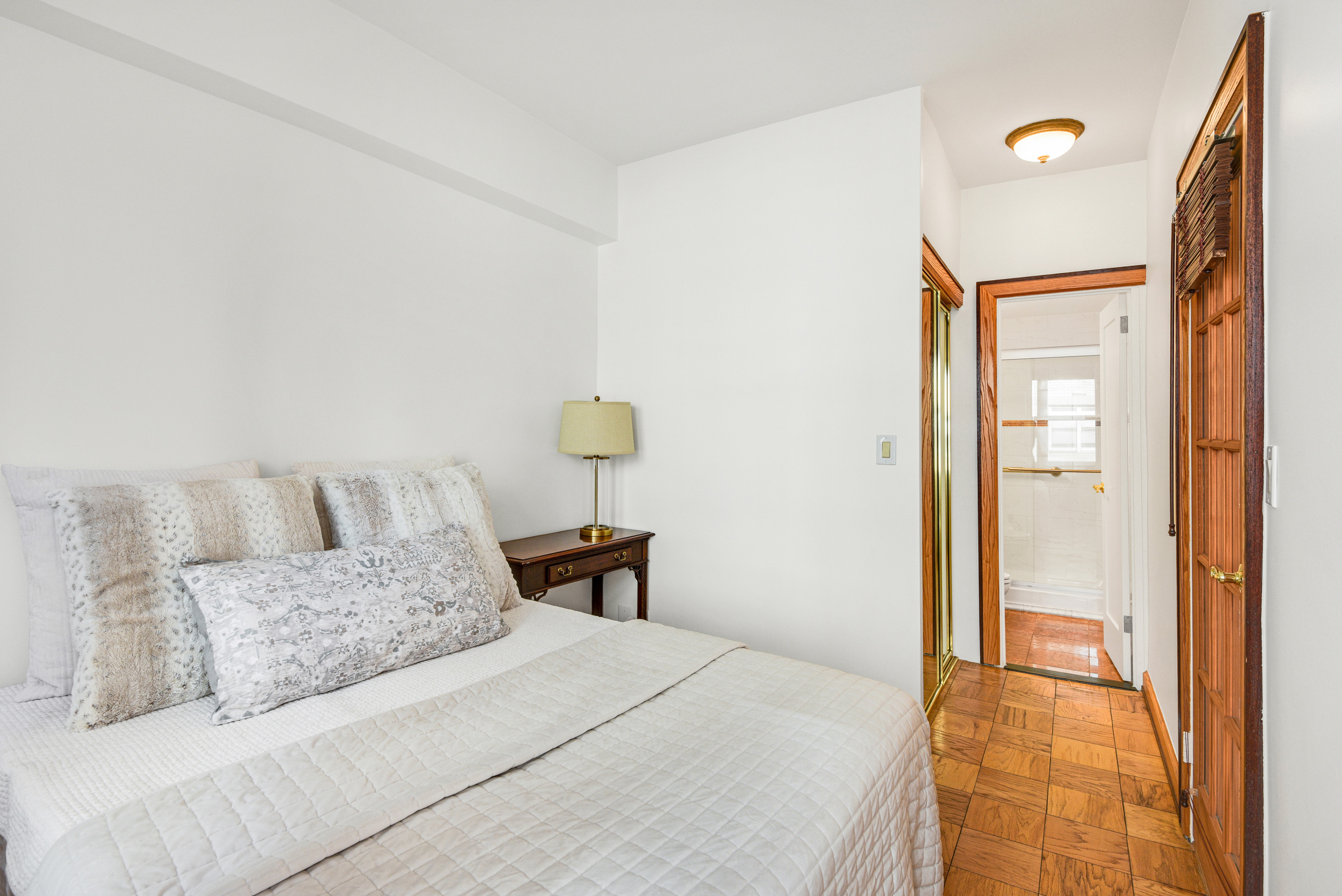 520 East 72nd Street, Unit 10P Manhattan, NY 10021 - Photo 11 of 13 a bedroom with a bed and a lamp
