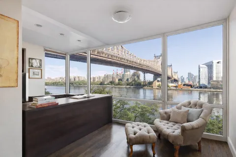 a dining room with furniture and a floor to ceiling window