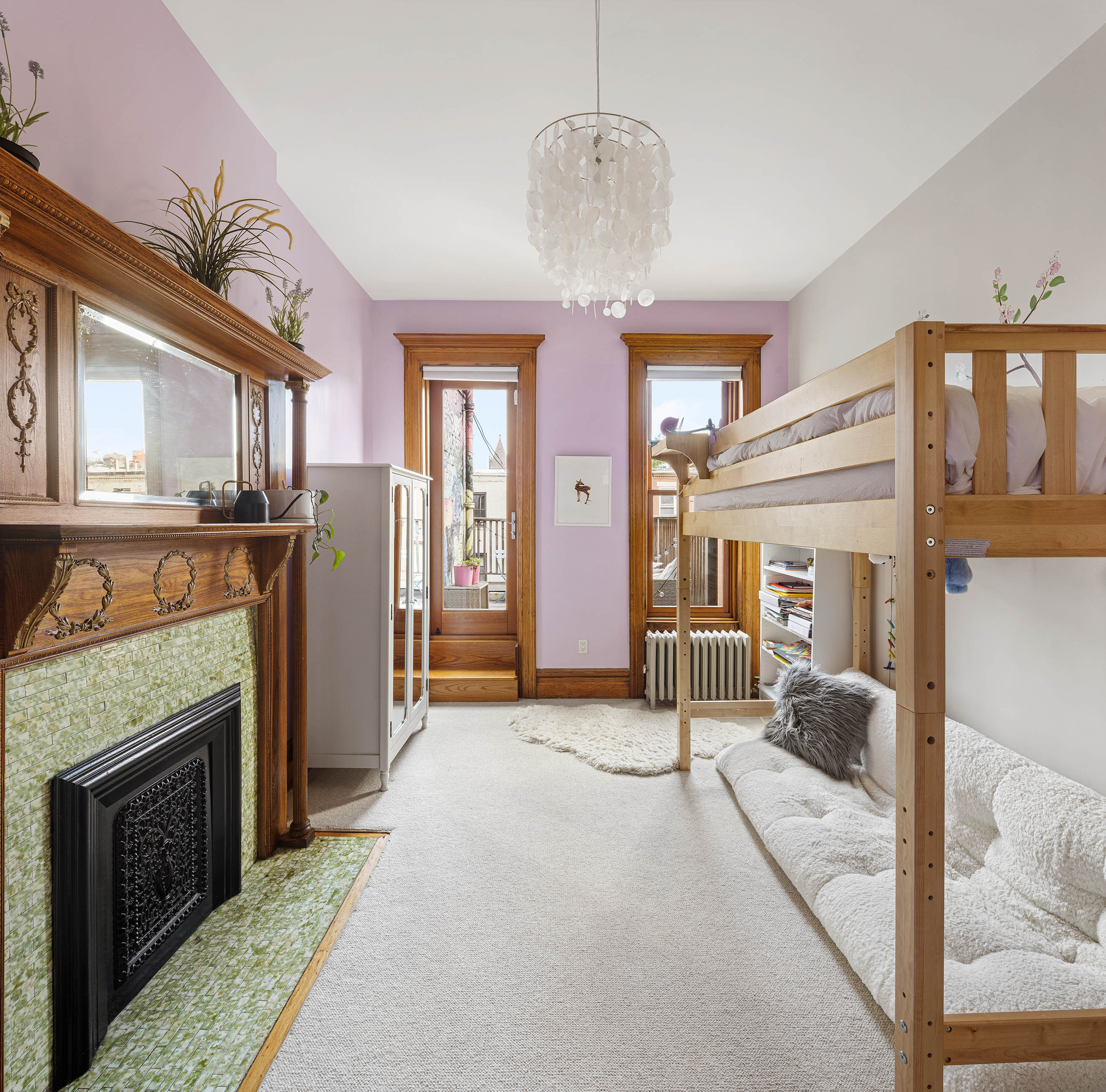 89 West 119th Street Manhattan, NY 10026 - Photo 13 of 22 a view of livingroom with furniture chandelier and fireplace