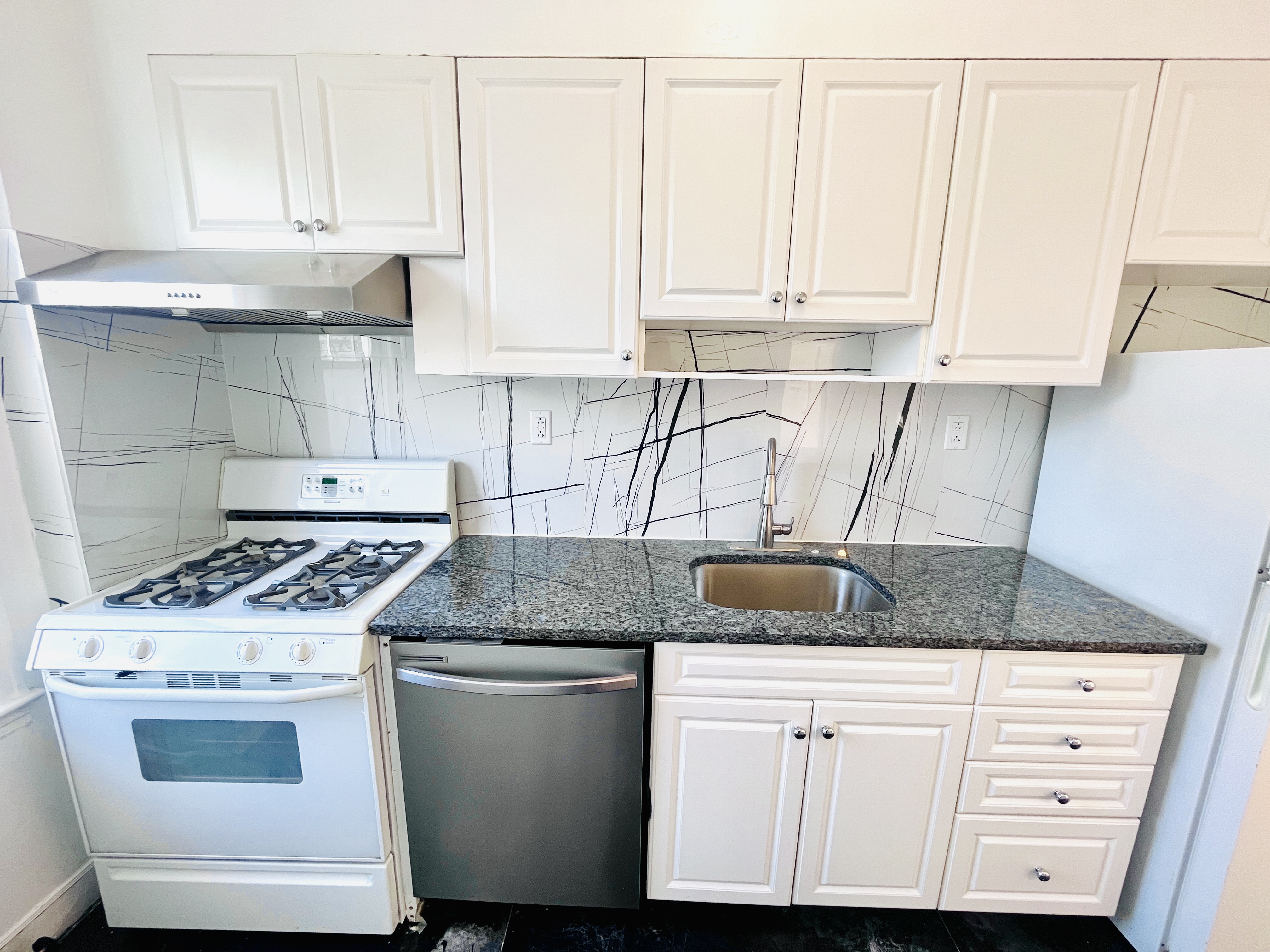 63-33 Haring Street, Unit 2F Queens, NY 11374 - Photo 4 of 7 a kitchen with granite countertop white cabinets and a sink